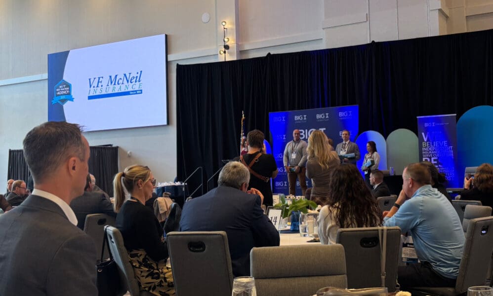V.F. McNeil Insurance logo on overhead being featured as a Best Practices award winner.