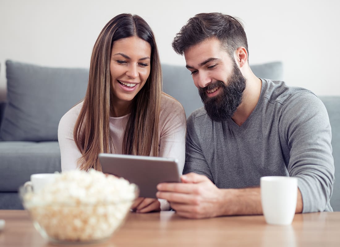 Blog - Happy Couple Looking at a Tablet Together