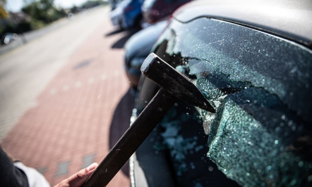 Prevent auto theft: Tips to protect yourself, your vehicle & your property. Hammer smashing out car window