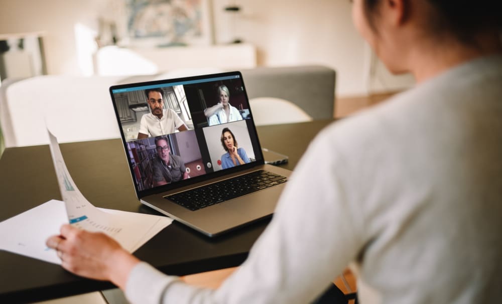 5 Tips for Ensuring Work From Home Safety and Security. Female employee on Zoom call with colleagues