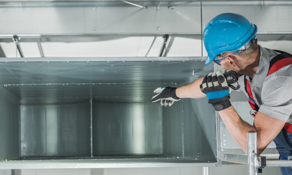 Smart Growth: Insurance Solutions for Expanding HVAC Companies in Connecticut. HVAC tech performing heating and cooling checks.