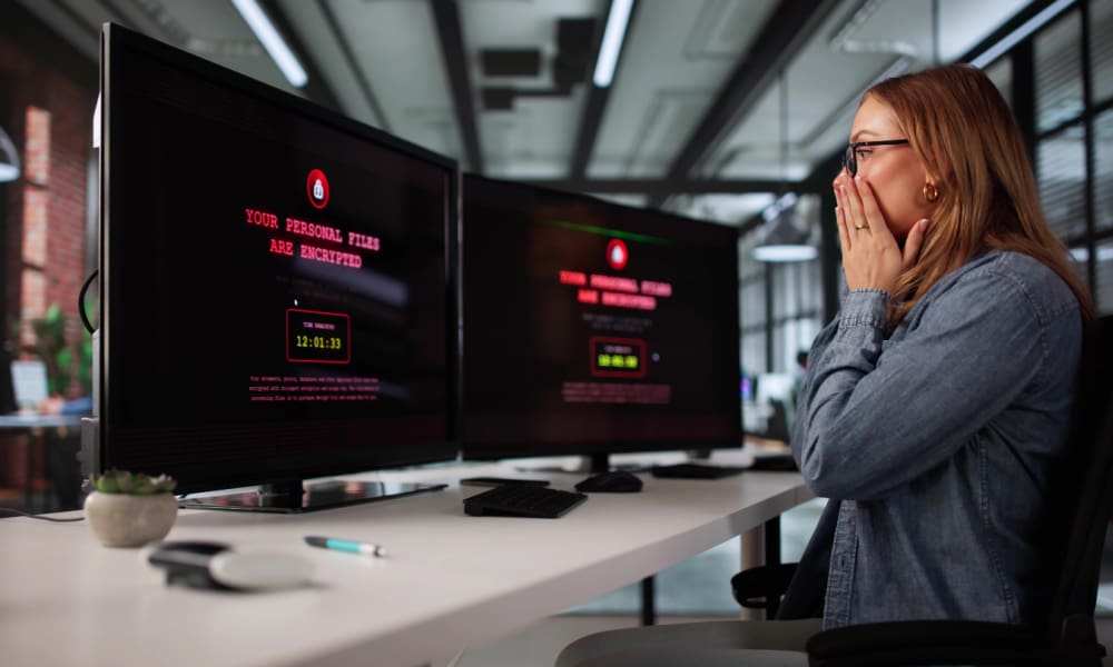 Cyber Insurance for Connecticut Businesses: What You Need to Know. Female employee alarmed over her locked out computer.