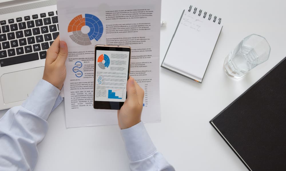 Connecticut Business Owners: Are You Protected Against Employee-Related Threats? Employee photographing confidential documents with mobile phone.