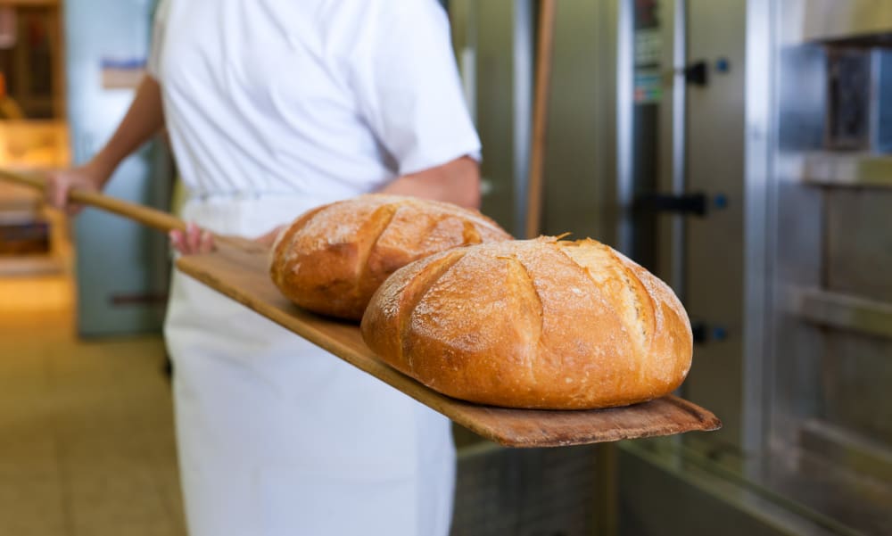 Bakery & Baked Goods Insurance in Connecticut: Protecting Your Sweet Success. Bread coming out of oven.