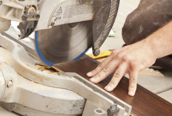 Flooring Contractors Insurance in Connecticut. Flooring contractor using circular saw.