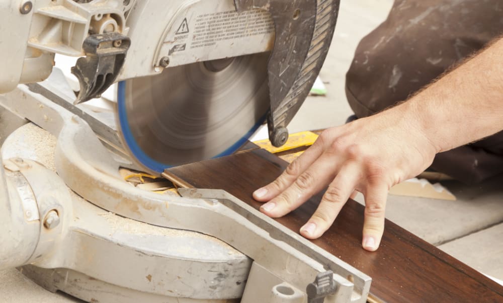 Flooring Contractors Insurance in Connecticut. Flooring contractor using circular saw.