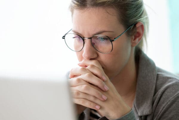 Professional woman reviewing business insurance renewal.