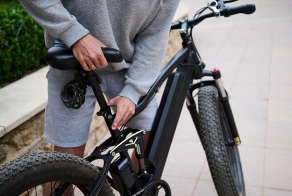 Insurance for E-Bikes and Pedal-Assisted Microcars in Connecticut. Man adjusting seat on e-bike.