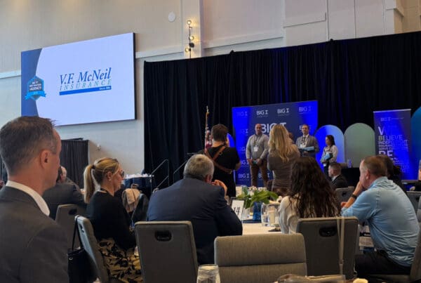 V.F. McNeil Insurance logo on overhead being featured as a Best Practices award winner.